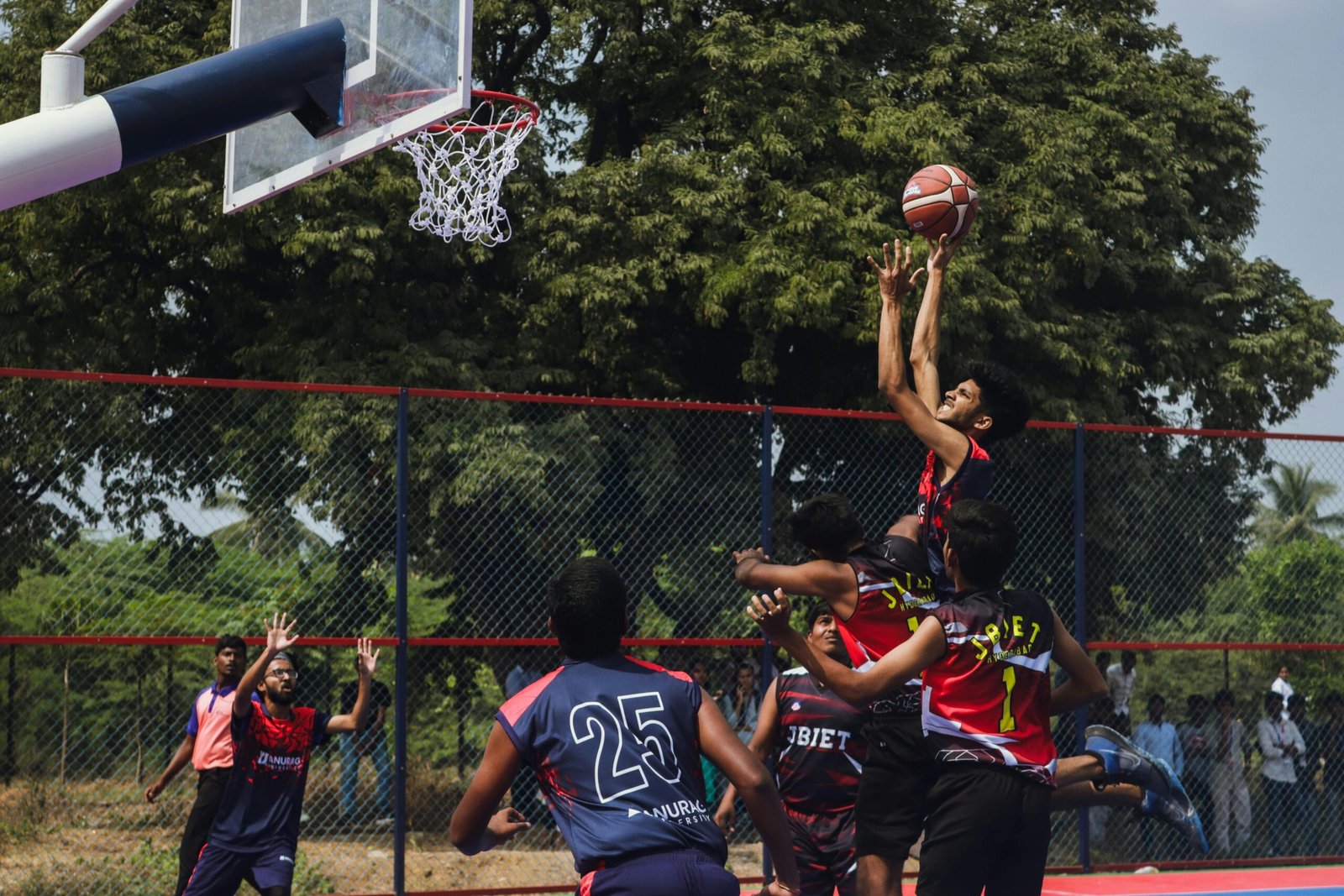 Players in action during an intense outdoor basketball game, showcasing athletic skills.